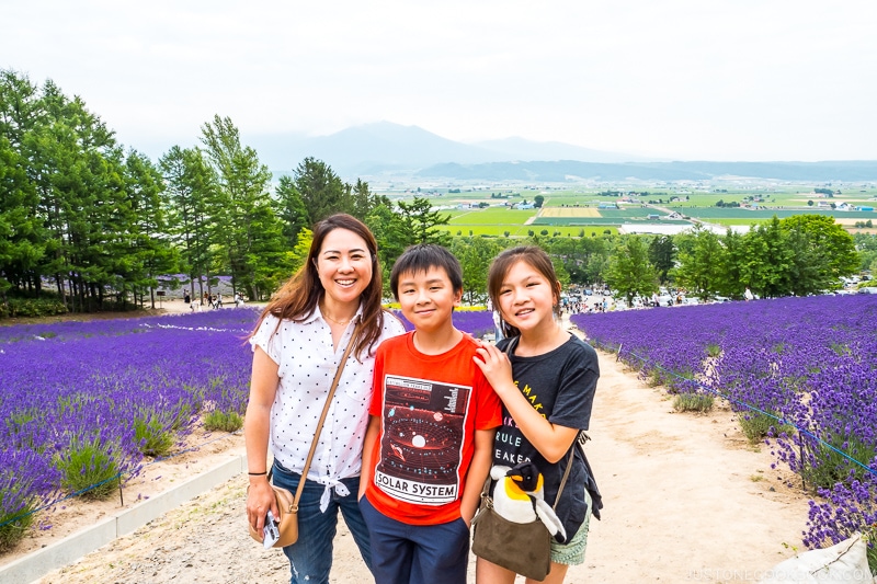 a woman with two children in front of lavender fields