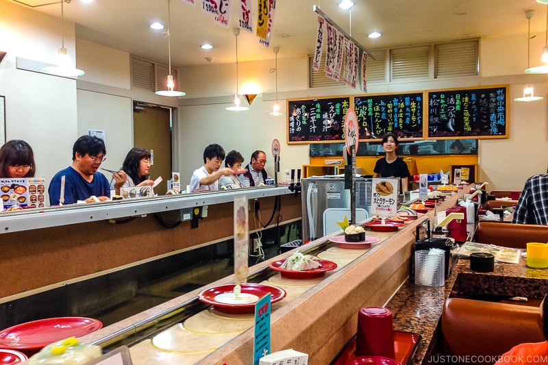 customer sitting at the counter in conveyor belt sushi Toppi sushi