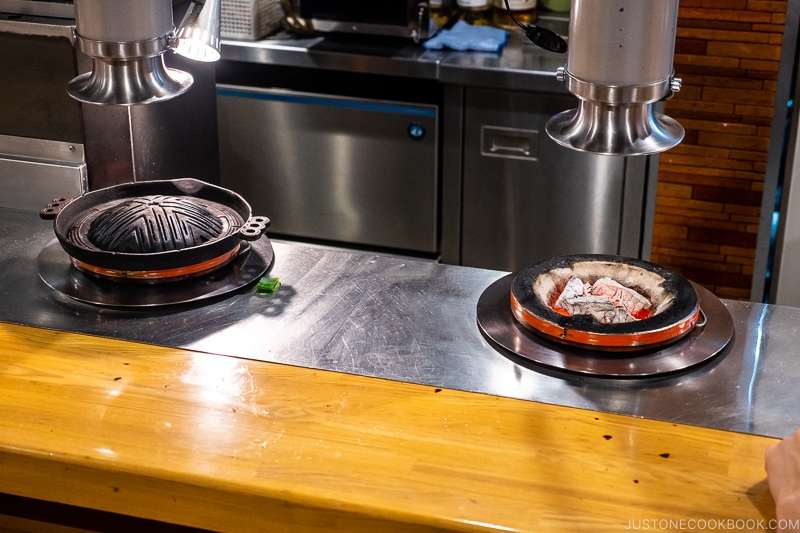 a grill with metal grate and a grill with charcoal