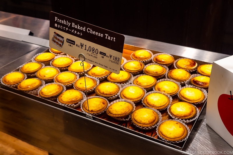 freshly baked cheese tarts on a tray