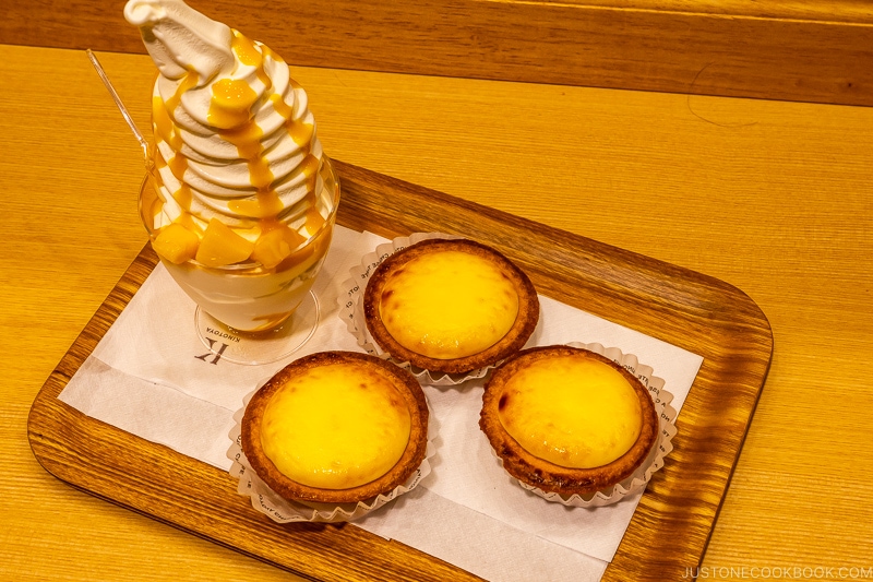 mango ice cream with cheese tart on a wood tray