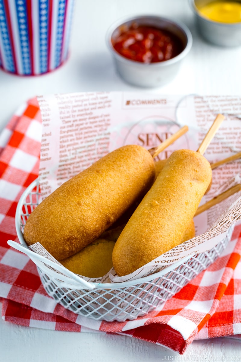 A basket containing corn dogs.