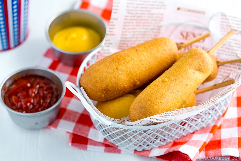 A basket containing corn dogs.