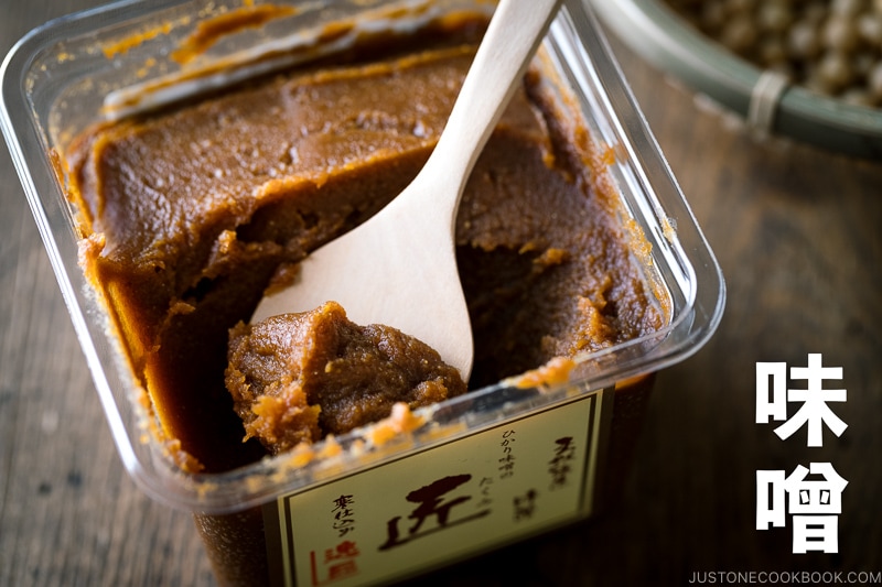 tub of miso with a wooden spoon with miso written in kanji