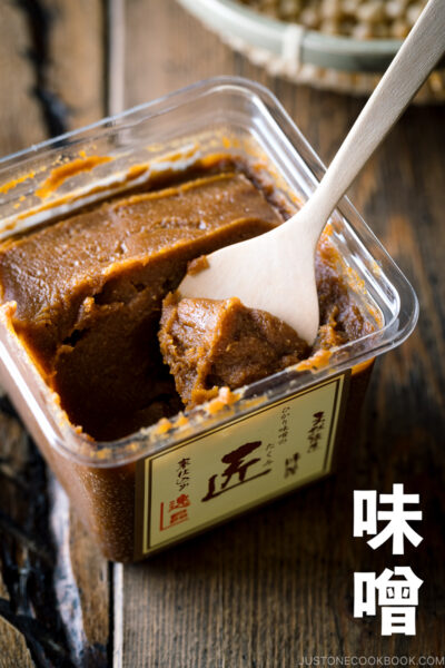 tub of miso with a wooden spoon with miso written in kanji