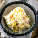 A ceramic bowl containing the Japanese potato salad.