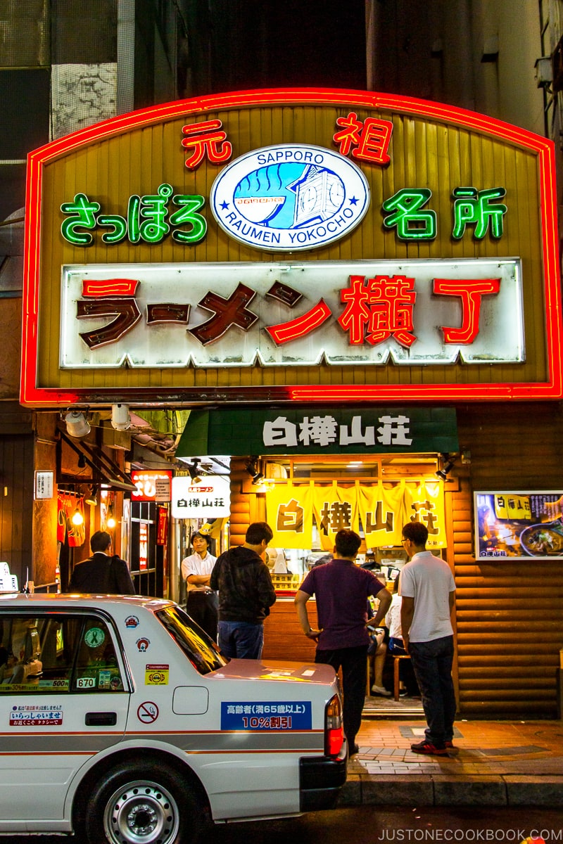 people standing in front of ramen shop at Ganso Ramen Yokocho (Original Ramen Alley)