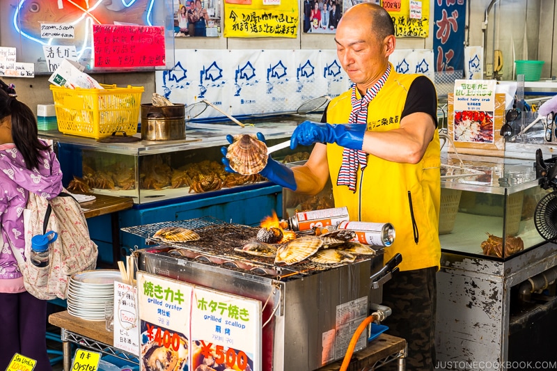 man grilling oyster and scallops