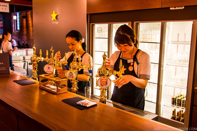 workers pouring beer from tap