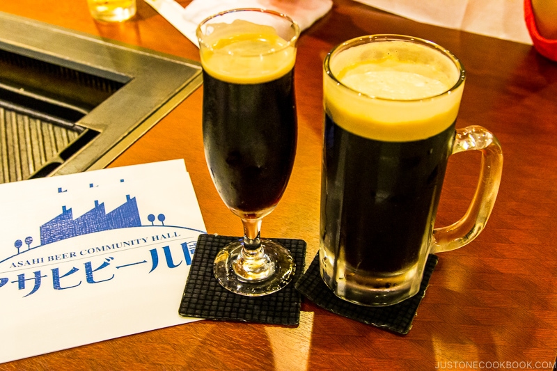 Asahi black beer in a mug and glass on wood table
