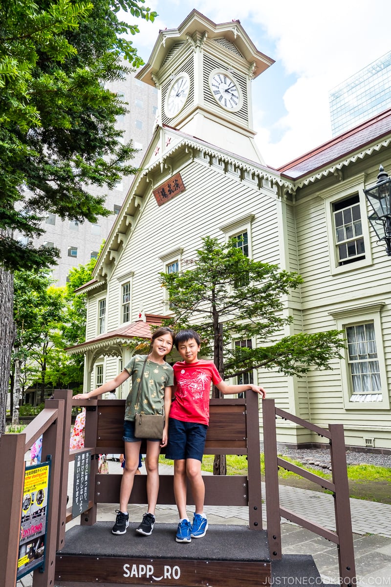 two children in front of Sapporo Clock Tower