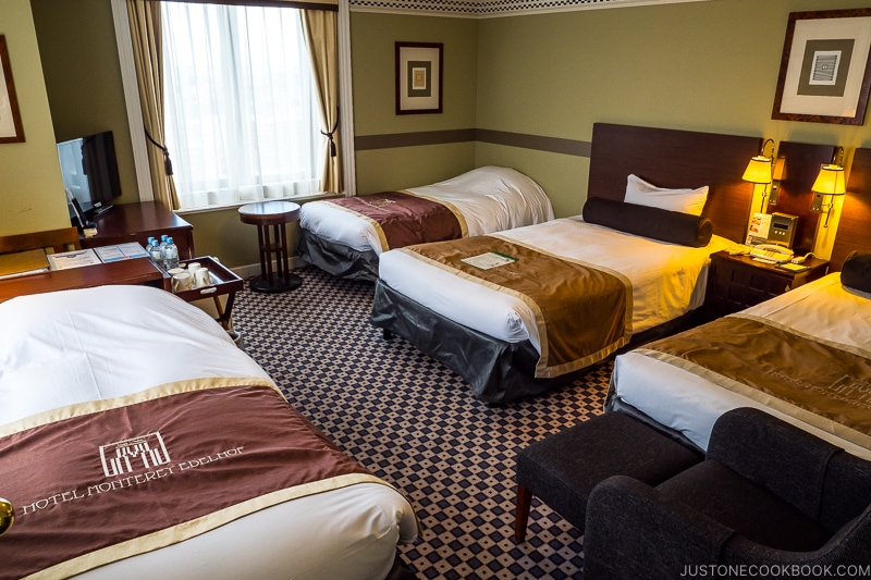 four hotel beds inside the room at Hotel Monterey Edelhof Sapporo
