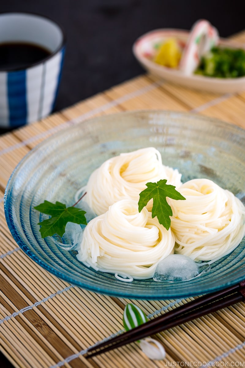 A blue glass bowl containing somen noodles.