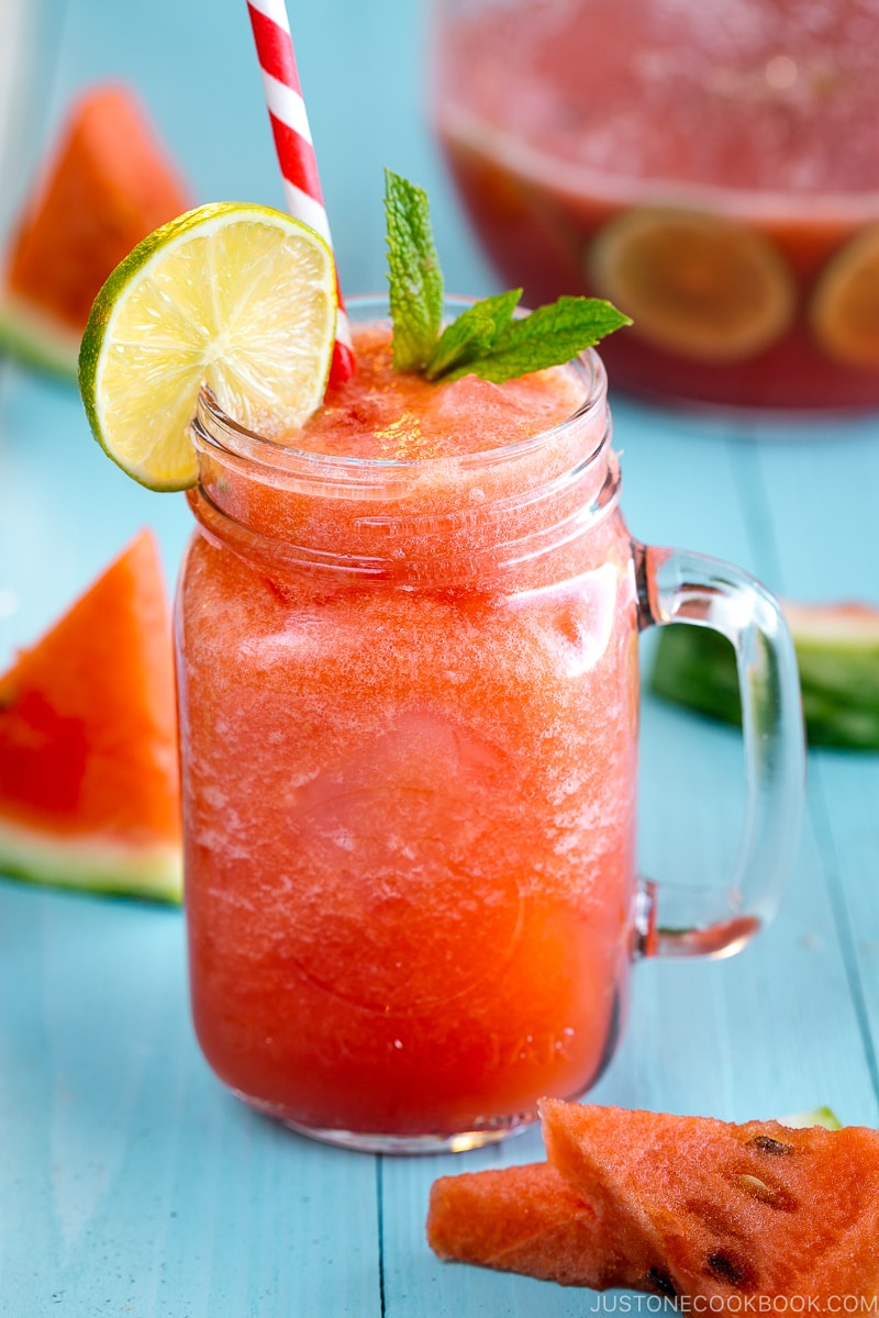 A glass jar containing homemade watermelon juice.