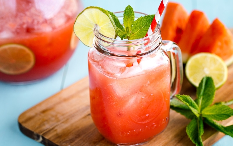 A glass jar containing homemade watermelon juice.