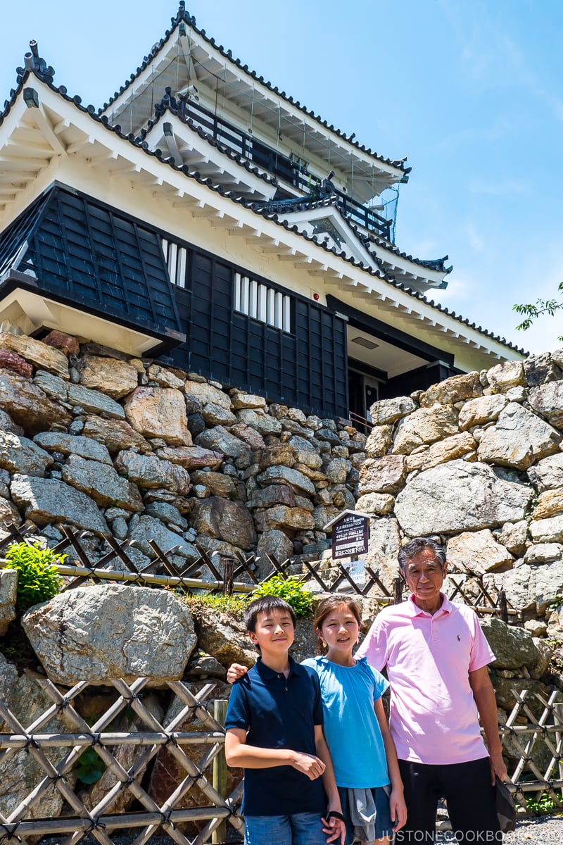 two children and an older man in front of Hamamatsu Castle