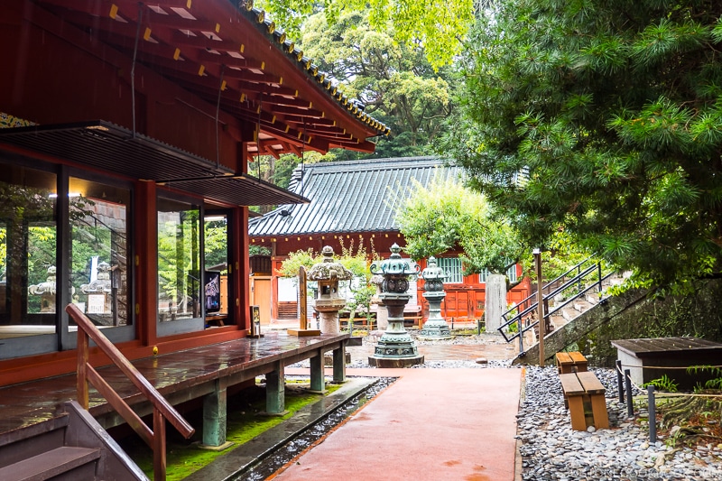 stone lanterns next to shrine buildings