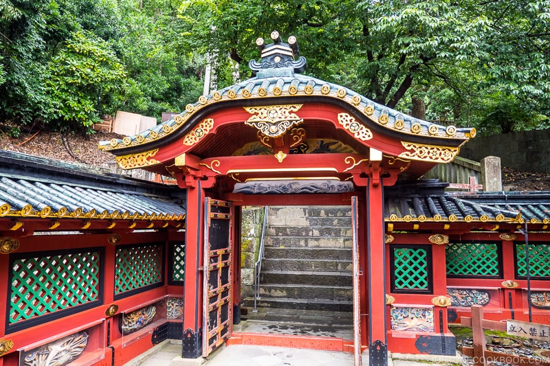 ornate red gate with stone steps in the back