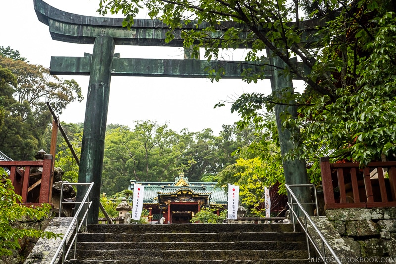 stone torii gate with a shrine in the back