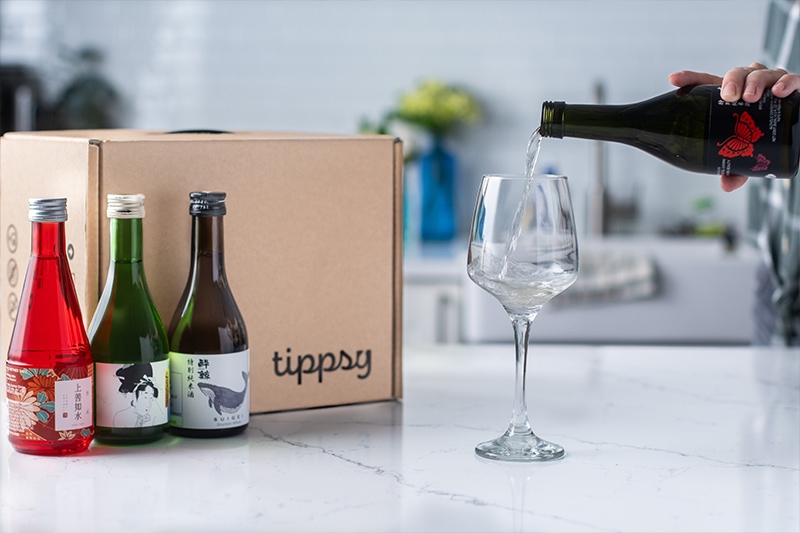 lifestyle image of sake pouring with Tippsy sake box