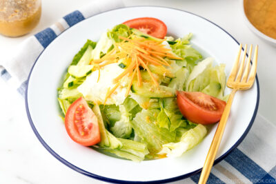 A plate containing salad drizzled with Ume Miso Dressing.