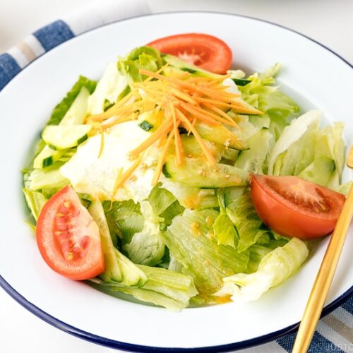 A plate containing salad drizzled with Ume Miso Dressing.