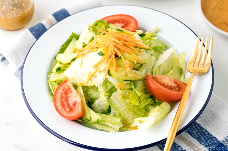 A plate containing salad drizzled with Ume Miso Dressing.