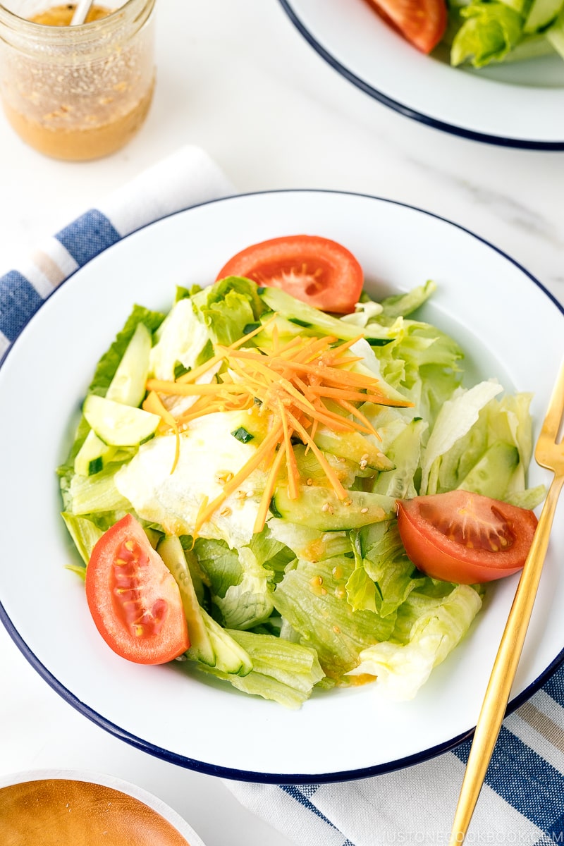 A plate containing salad drizzled with Ume Miso Dressing.