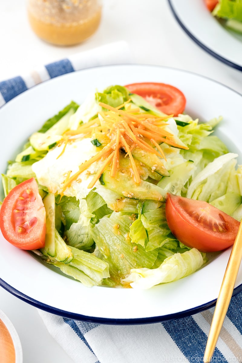 A plate containing salad drizzled with Ume Miso Dressing.