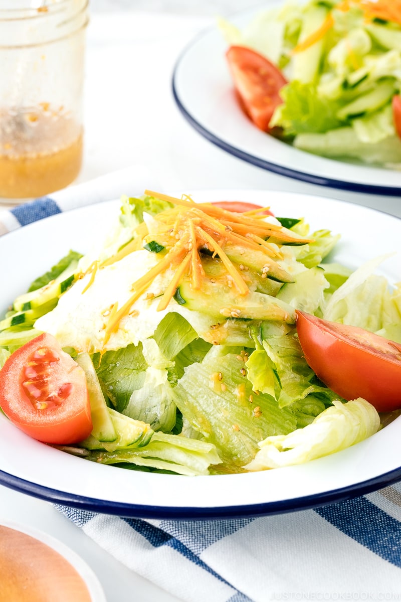 A plate containing salad drizzled with Ume Miso Dressing.