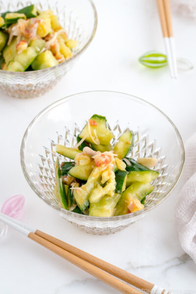 Glass bowls containing Smashed Cucumber Salad with Ume Dressing.