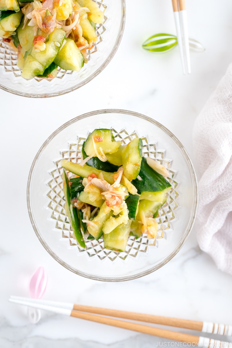 Glass bowls containing Smashed Cucumber Salad with Ume Dressing.