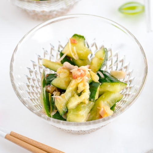 Glass bowls containing Smashed Cucumber Salad with Ume Dressing.