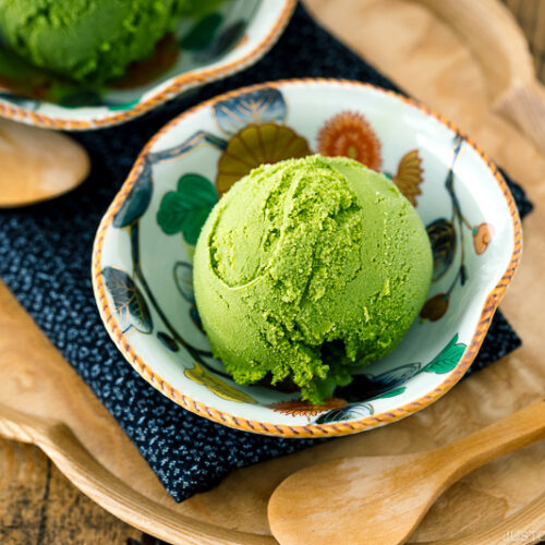 A Japanese kutaniware bowl containing matcha green tea ice cream served with wooden spoon.