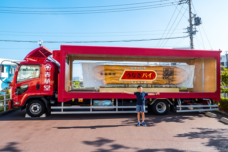 a boy in front of Unagi Pie truck