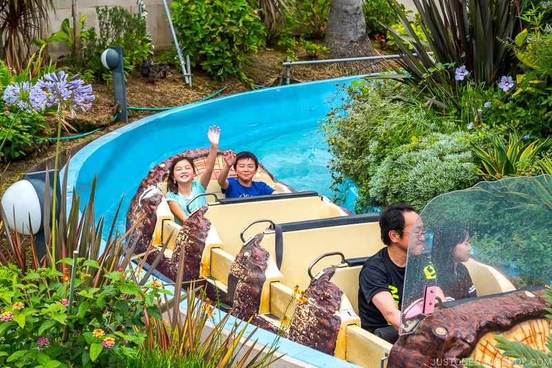 kids in a water ride at amusement park