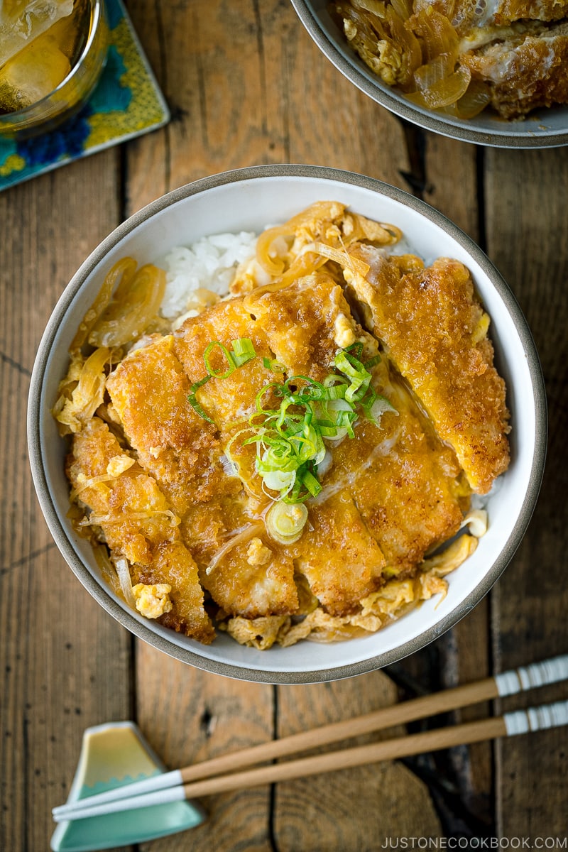 A ceramic bowl containing Katsudon (Japanese Pork Cutlet Rice Bowl).