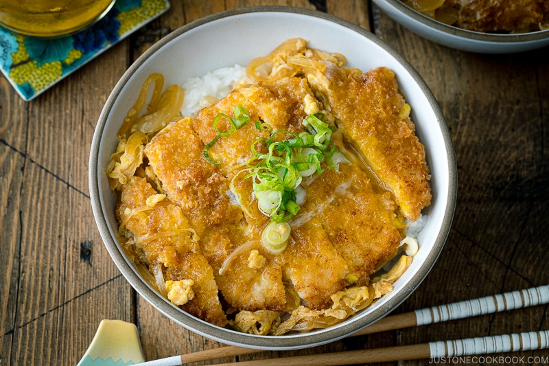 A ceramic bowl containing Katsudon (Japanese Pork Cutlet Rice Bowl).