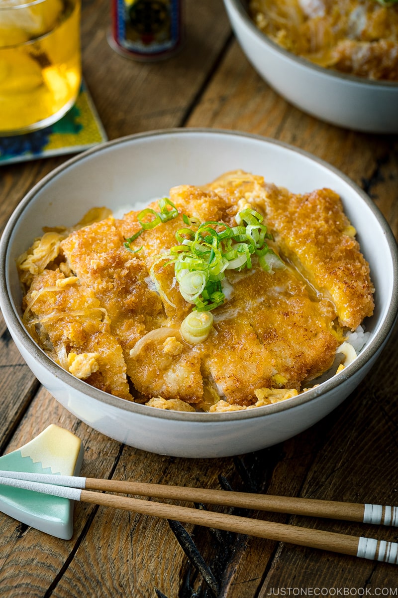 A ceramic bowl containing Katsudon (Japanese Pork Cutlet Rice Bowl).