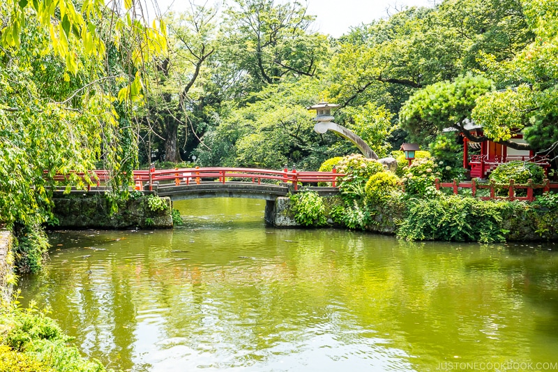 a Japanese garden with bridge at Mishima Taisha