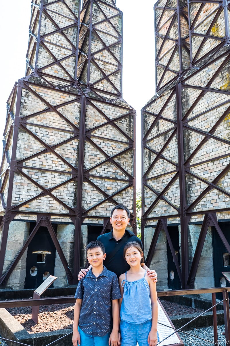 a man and 2 children in front of Nirayama reverberatory Furnace