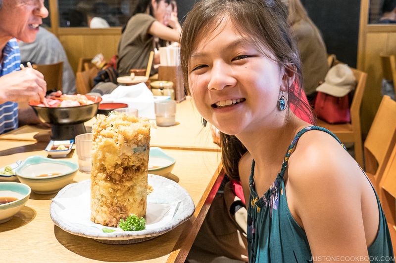 girl next to a fried seafood tower