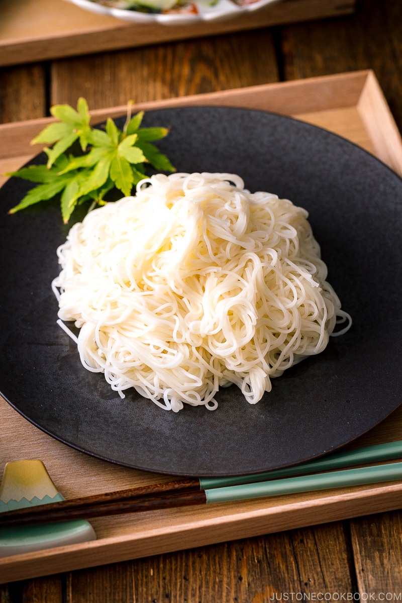 A black plate containing somen noodles.