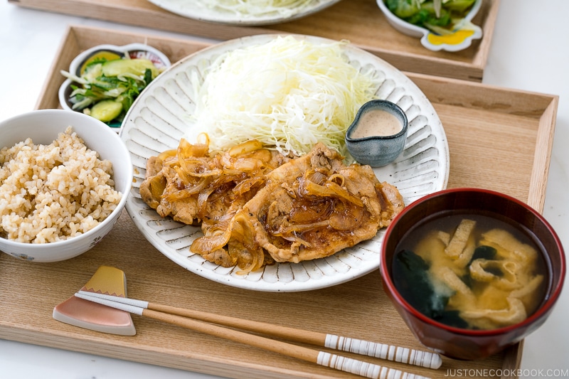 Ginger pork served with shredded cabbage on a white ceramic plate.