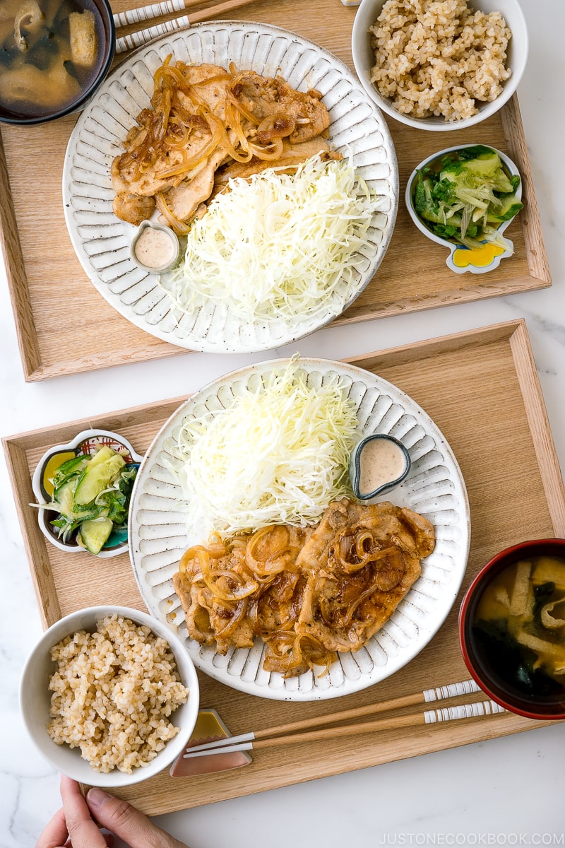 Ginger pork served with shredded cabbage on a white ceramic plate.