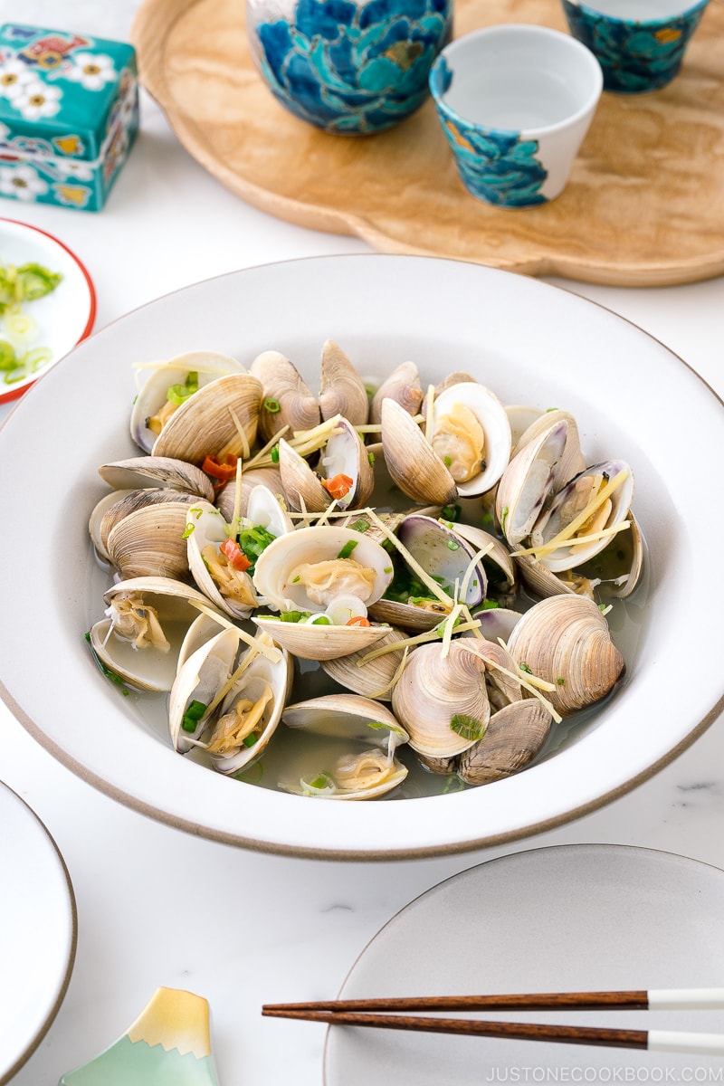 A ceramic bowl containing Japanese Sake-Steamed Clams.