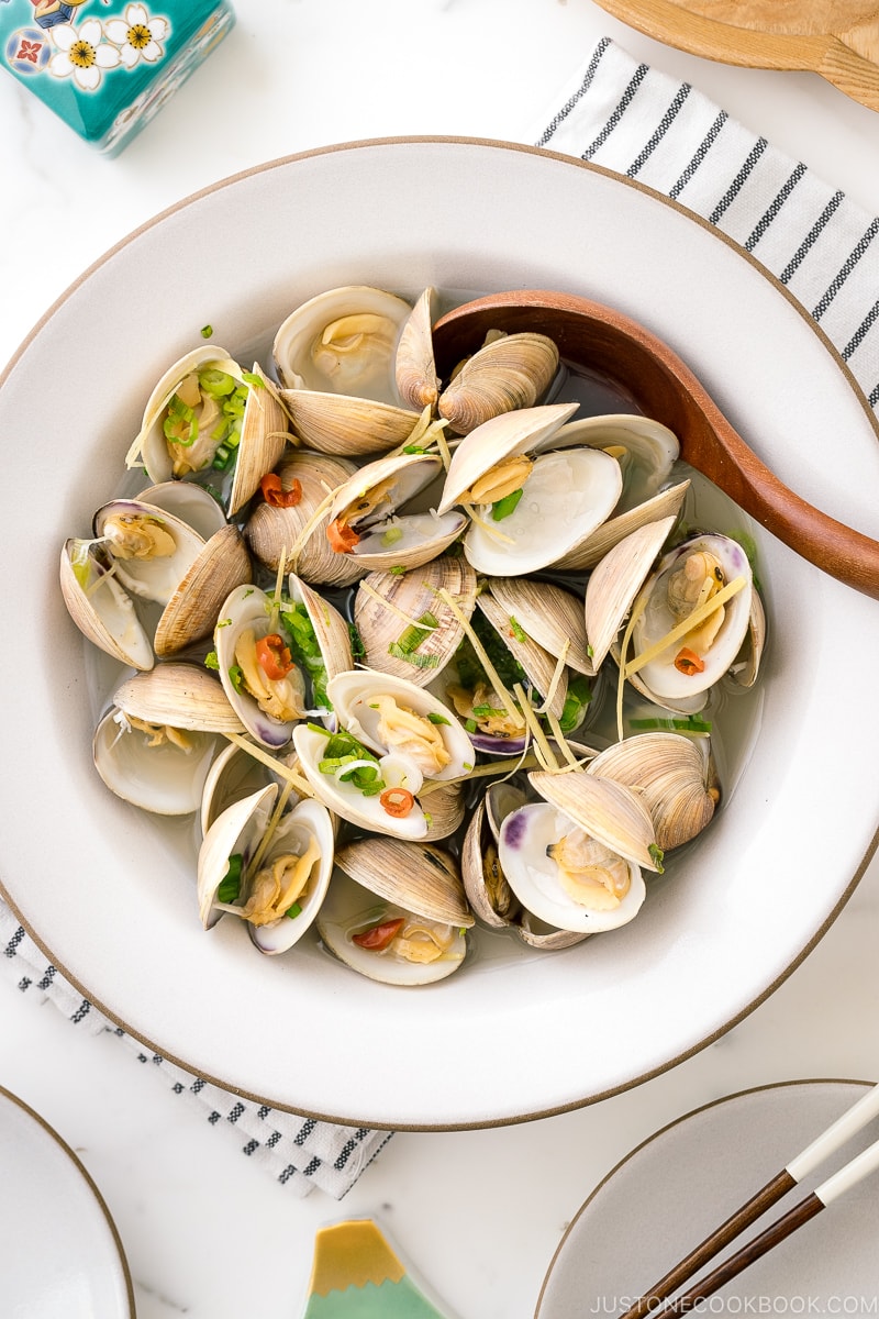 A ceramic bowl containing Japanese Sake-Steamed Clams.