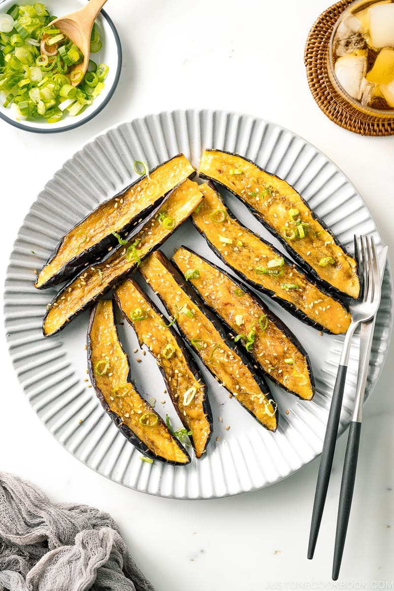 A white plate containing Miso Glazed Eggplant.