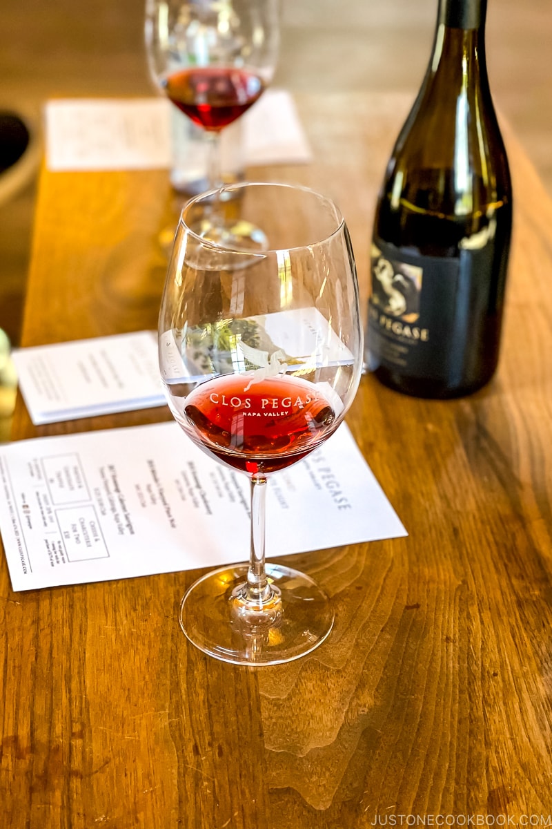 wine in a glass on wood table