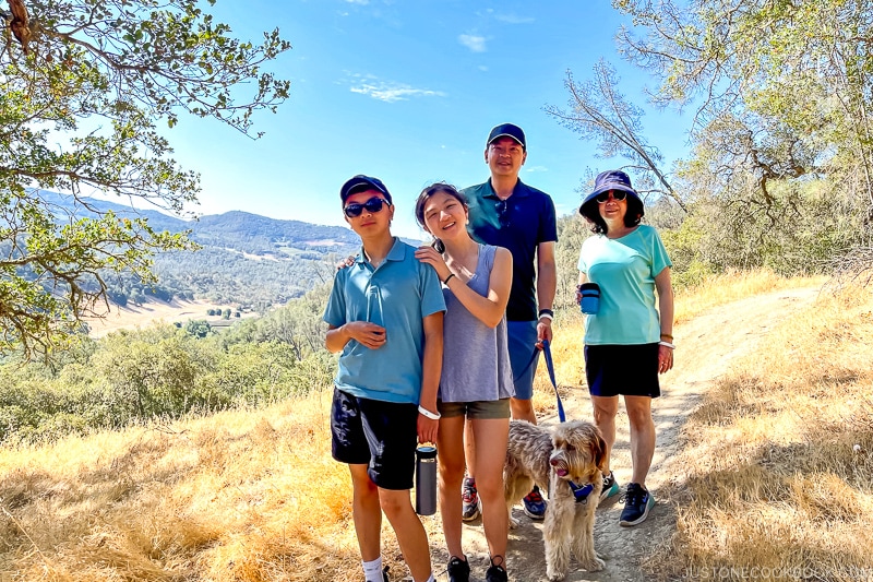 family with dog on hiking trail